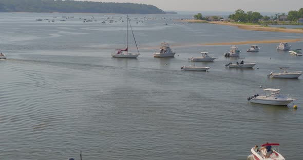 Top Down Aerial View of a Speed Boat Passing Near a Pier in Cold Spring Harbor alt