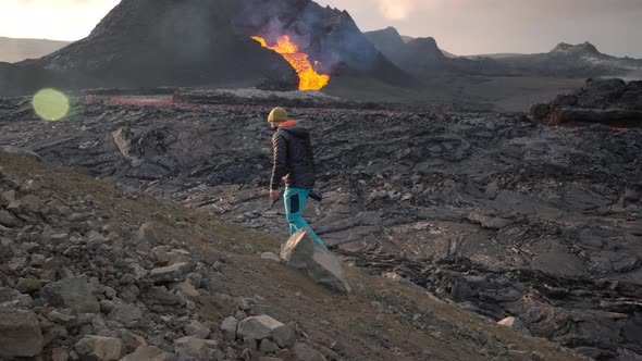 Photographer In Landscape With Lava Erupting From Fagradalsfjall Volcano alt