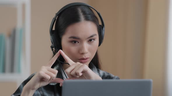 Asian Female Office Worker Wears Headset Has Distant Conference Video Calling with Laptop Computer alt
