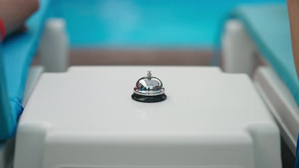 Hotel Bell with Little Male and Female Hands Pressing in Slow Motion Outdoors alt