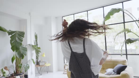 Happy Young Millennial Woman Dancing at Home Having Fun Celebrating with Fun Dance Moves Enjoying alt