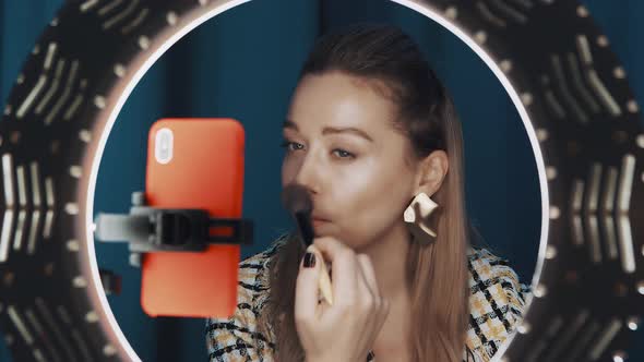 View of Woman Fashion Blogger Contouring Face in Front of Ring Light for Channel