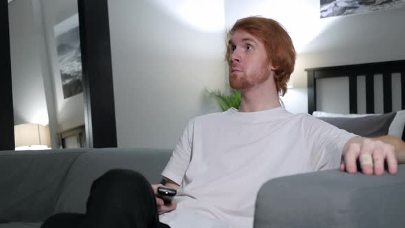 Happy Redhead Man Watching Comedy on TV alt