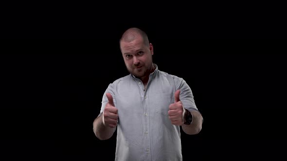 Man in Shirt on Isolate Black Background Shows Class Sign. Thumb Up Showed By Bearded and Bald Guy alt