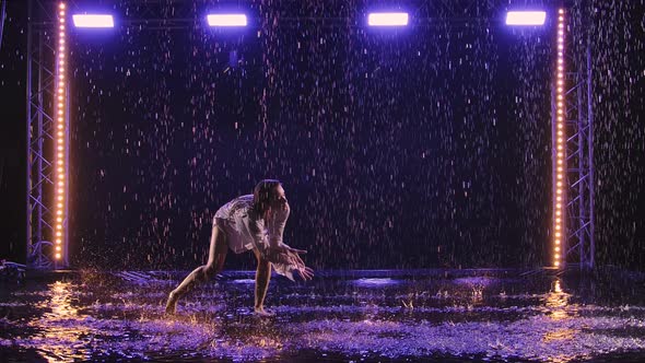 Contemporary Dance Ballerina Dances Sensually in Rain on Water Surface Creating Splashes alt