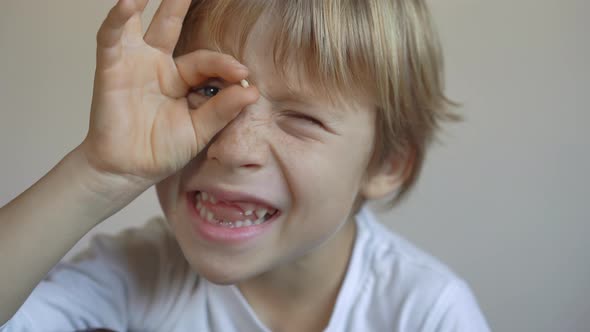 Little Boy Shows That Some of His Milk Teeth Had Fallen Out. Concept of Tooth Change in Children alt