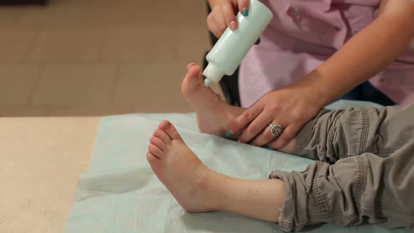 Doctor Pours Gel for Ultrasound on Leg of Child alt