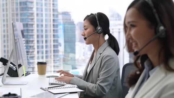 Asian businesswoman telemarketing team working in call center city office