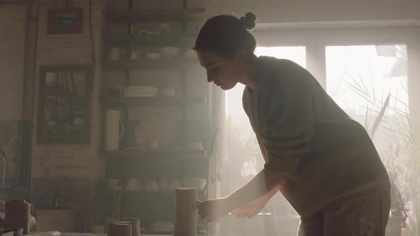 Woman Is Cutting Clay Into Pieces alt