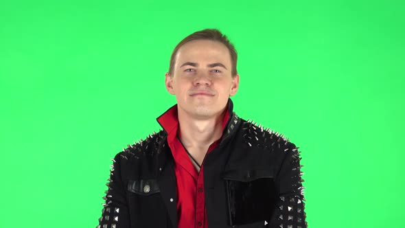 Man Smiling While Looking at Camera and Arms Crossed. Green Screen alt