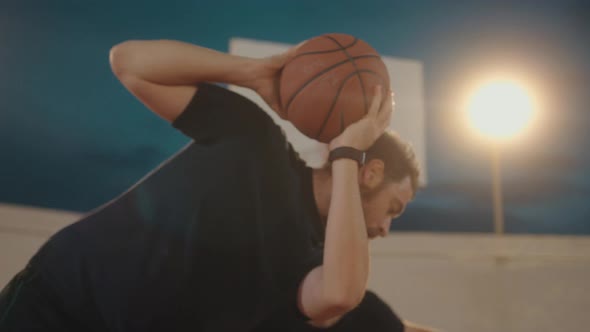 Close up pov action shot showing two friends playing basketball one on one alt