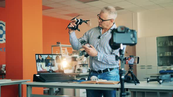 Robotics Teacher Is Talking To Adult Students During an Online Class alt