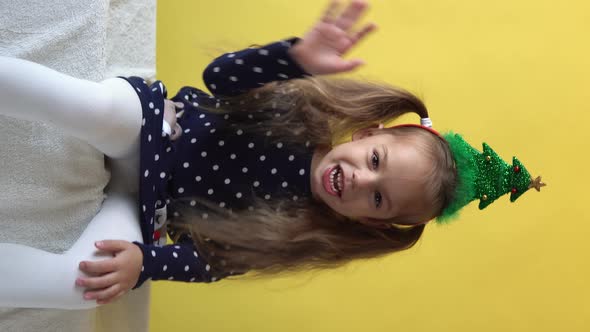 Vertical Portrait Emotion Cute Happy Cheerful Preschool Baby Girl in Santa Hat Looking On Camera At alt