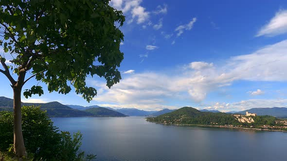Stunning time-lapse of Maggiore lake with Angera castle and Alps mountain range in background, Italy alt