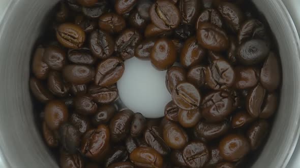 Coffee Beans Fall Into The Coffee Grinder, She Is Their Milling