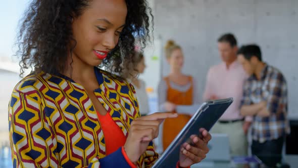 Young African american female executive working on digital tablet in modern office 4k alt