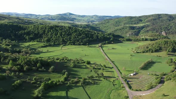 Aerial View Of Trees Green Meadows And Hills alt