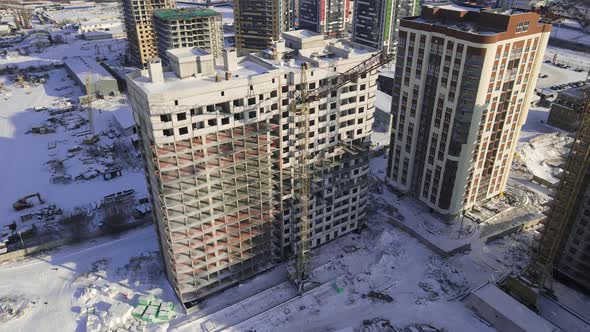 Aerial view to the construction works on the top of building alt