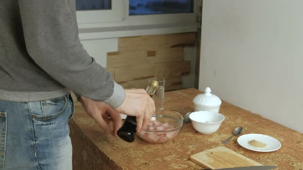 Man Makes a Marinade for Chicken. Opens the Soy Sauce, and Pours It Into the Bowl