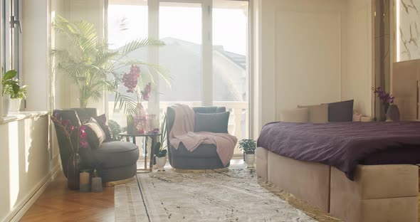 Bedroom Filled with Soft Natural Light From the Big Glass Door to the Balcony alt