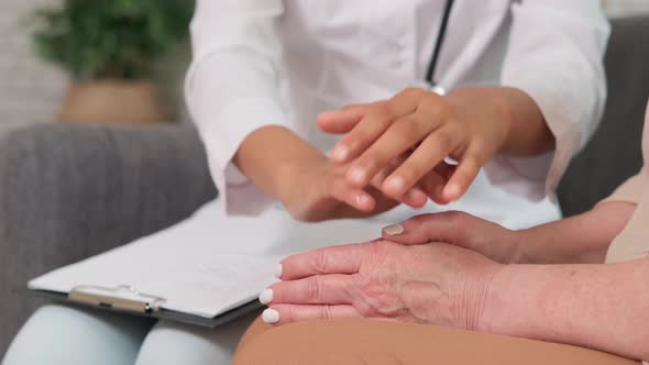 Afro American Woman Doctor Supports Senior Woman Holding Her Hands alt