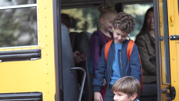 Little Pupils Saying Goodbye To School Bus Driver alt