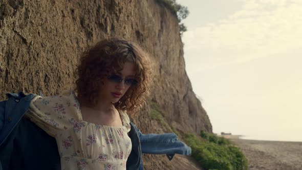 Woman Taking Off Sunglasses Posing on Beach Close Up alt