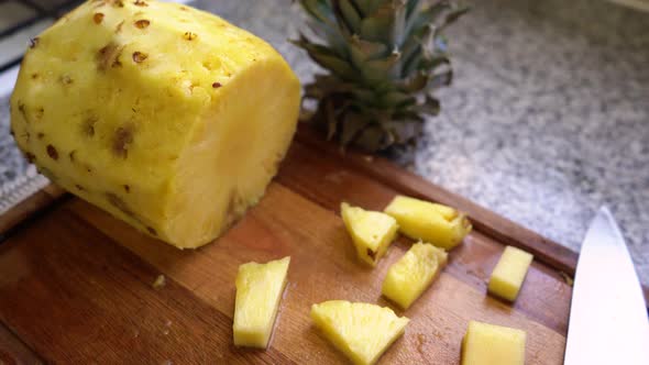 Fresh Pineapple Fruit Peeled And Cut On Wooden Board. dolly-out alt