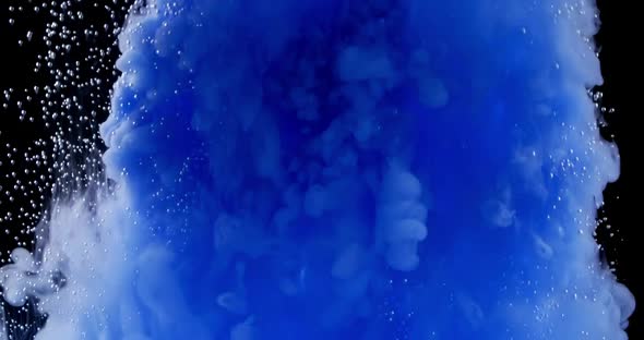 Blue Ink Clouds Spread in Water, Small Air Bubbles and Colored Smoke Spreading Underwater on Black alt