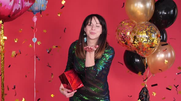 Beautiful Young Girl in Sparkling Dress Holding Present. alt