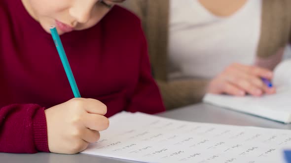 Close up of concentrated boy during doing math equation. Shot with RED helium camera in 8K. alt