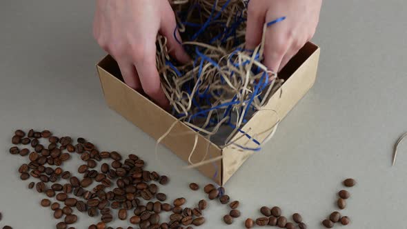 Woman is wrapping handmade coffee soap as souvenir for gifting or good for later sale