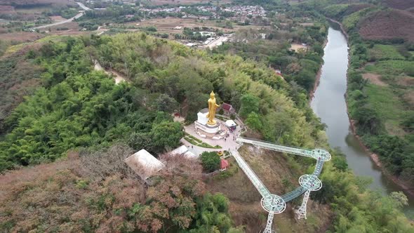 Aerial view by drone of the big buddha statue and skywalk by the Mekong river in Loei, Thailand