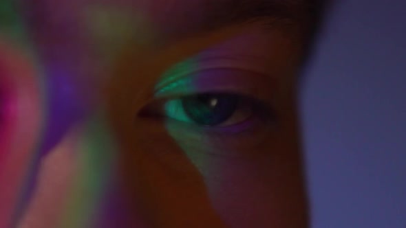 Extreme Close Up of Young Man Eye with Projector Reflection