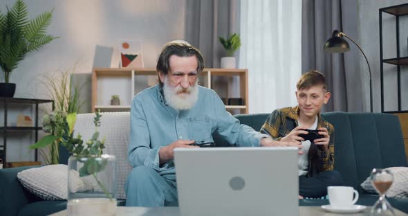 Granddad Celebrating Victory in Video Games Over His 12-aged Positive Grandson alt