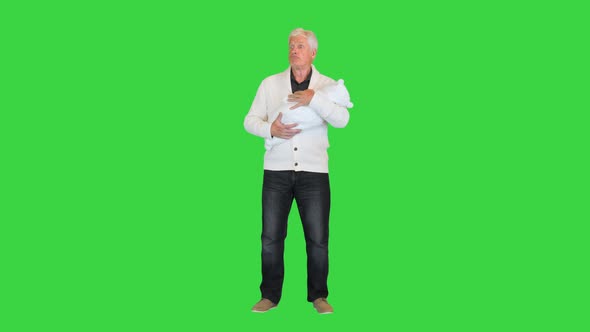 Shocked Grandfather Holding His Grandson on a Green Screen Chroma Key alt