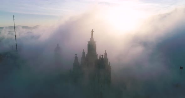 Aerial View of Tibidabo at Sunrise in Heavy Fog Like a Beautiful Ocean of Clouds