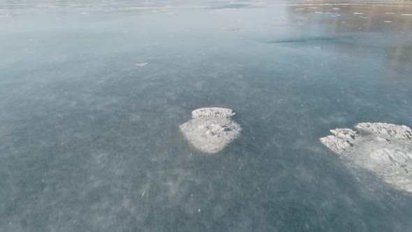 Drone Flight Over Frozen Lake Aerial Shot of Lake Surface on a Sunny Winter Day