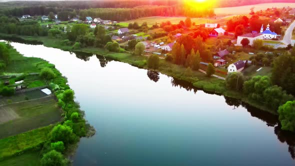 River at sunset in a city park with clouds reflecting in the water alt