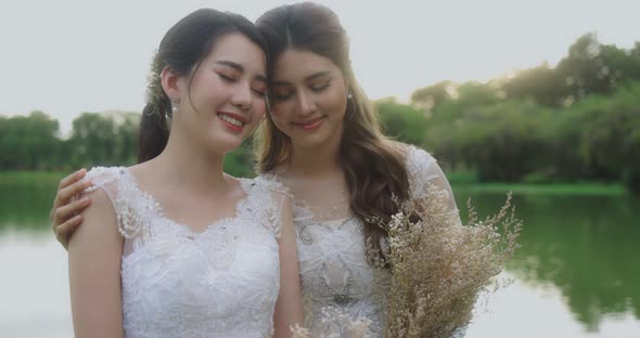 Asian Lesbian Married Couple Enjoying Romantic Moments Outside, Slow Motion. alt