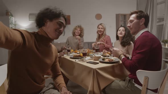 Man Making Photo with Friends during Dinner alt