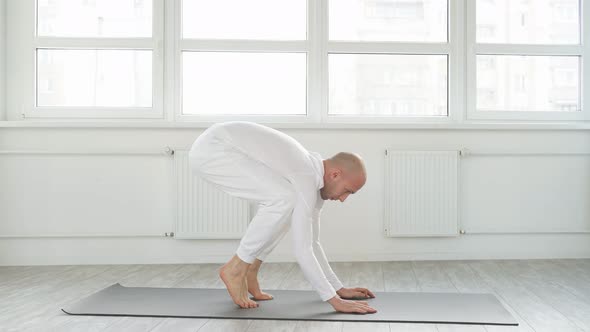 Side View on Sporty Yogi Man Working Out Doing Handstand Yoga Asana