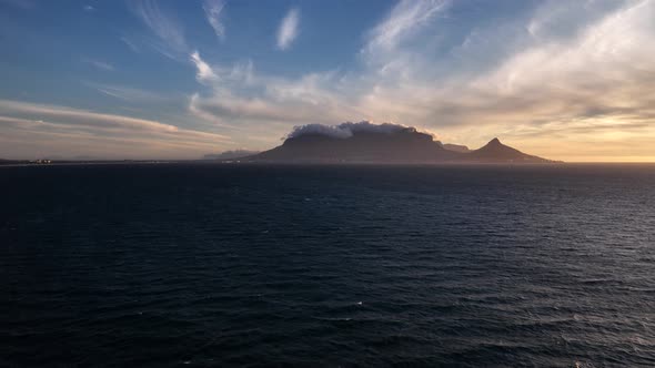 Table Mountain with its famous tablecloth at golden hour; aerial view alt