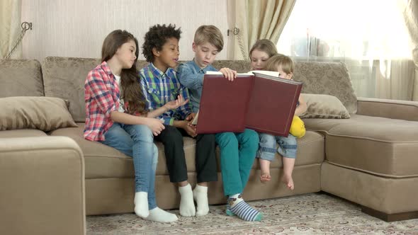 Children with a Big Book. alt