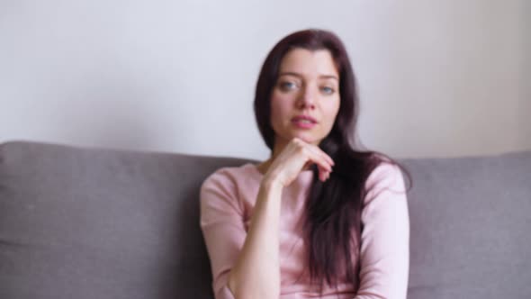 Girl at Home on the Background of a Light Wall alt