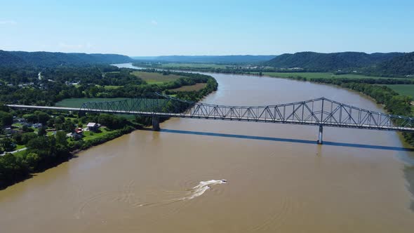 Carl Perkins Bridge crossing the Ohio River from Kentucky, aerial drone footage alt