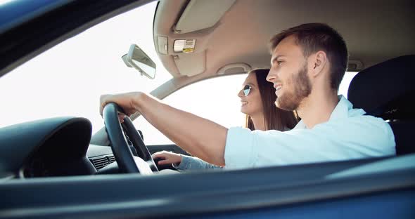 Couple Driving Car on Sunset