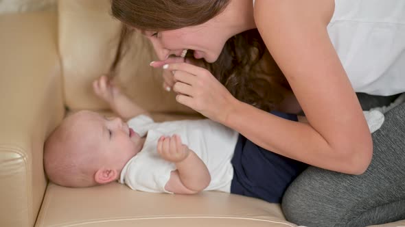 smiling mum enjoying bonding cuddling hugging spending time with baby. alt