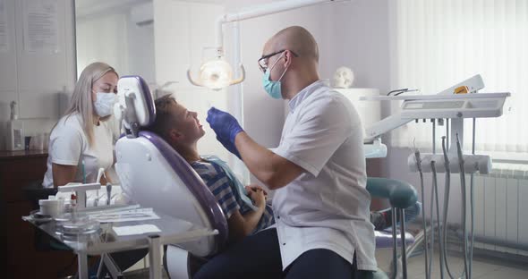 Dentist Checking Healthy Teeth of Teen Boy alt