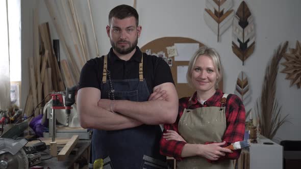 Portrait of a Man and a Woman in a Carpentry Workshop alt